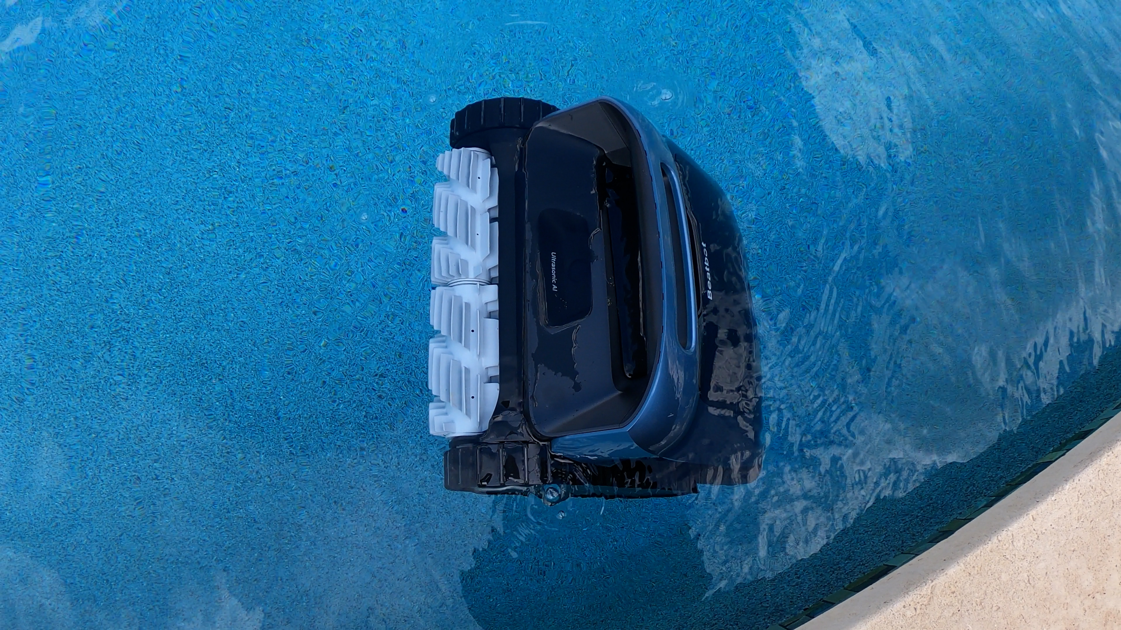 Beatbot AquaSense 2 Pro Floating Near Edge Of Pool