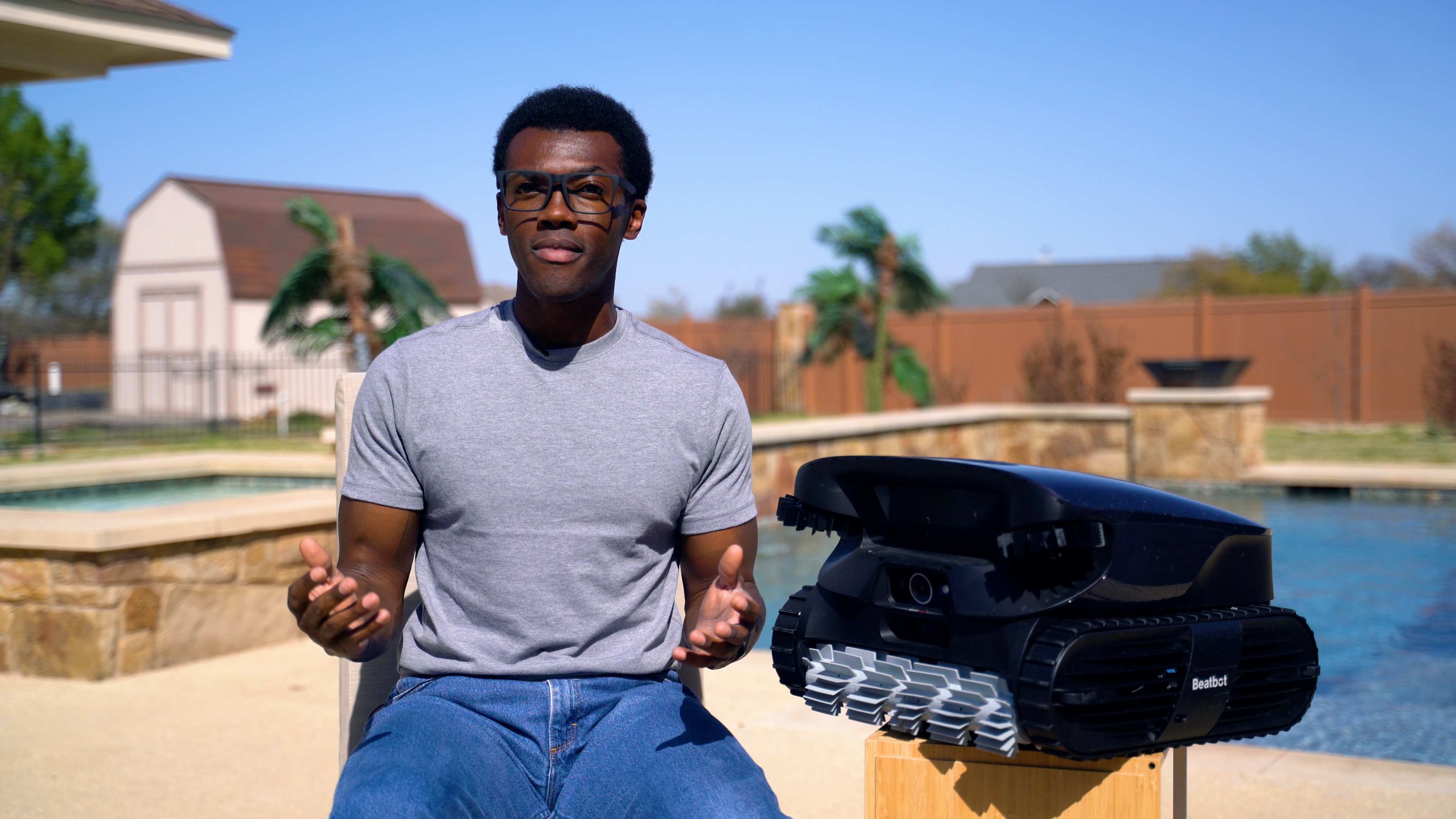 Beatbot AquaSense 2 Ultra Robot Poolside Person Sitting Sunny