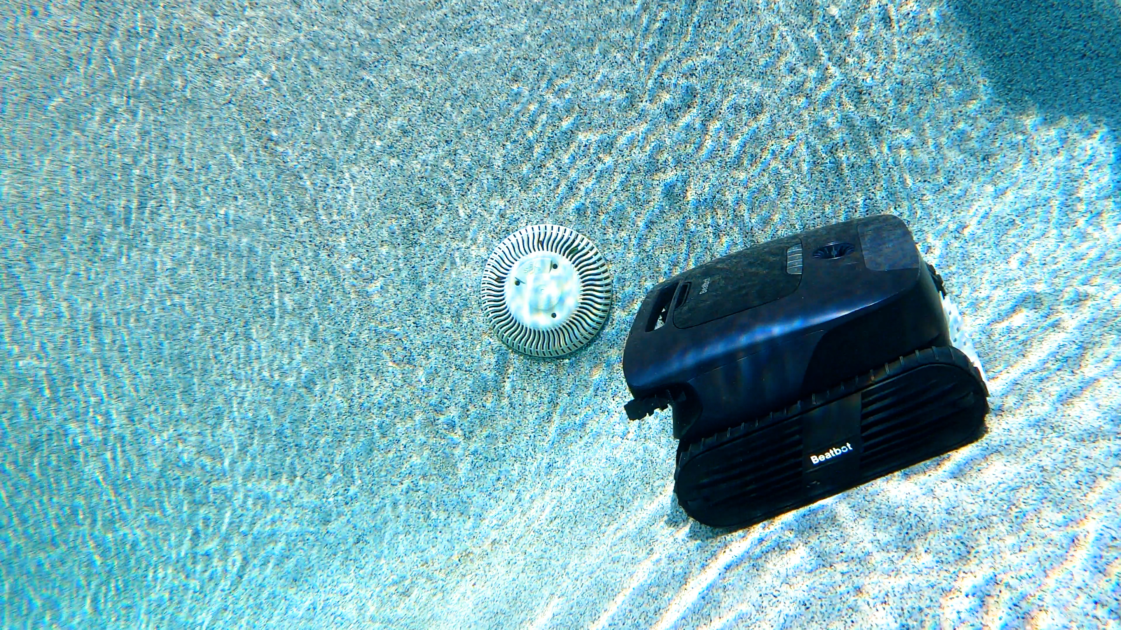 Beatbot AquaSense 2 Ultra Robot Resting Near Pool Drain Underwater