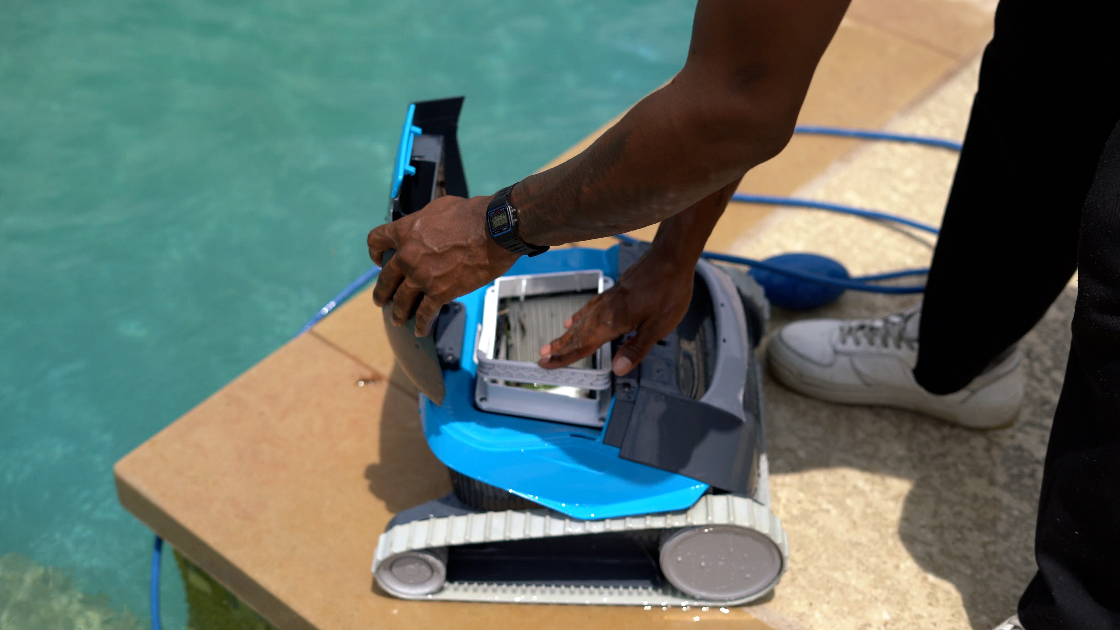 Dolphin Cayman Filter Basket Accessing Cleaning Poolside Closeup