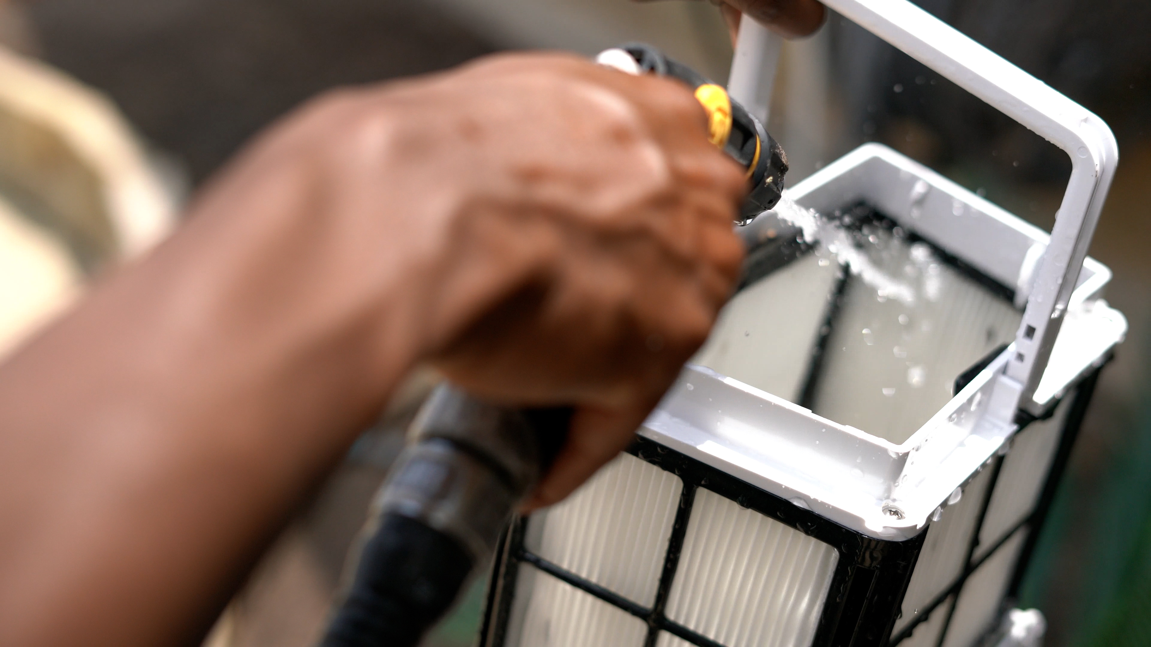 Dolphin Cayman Spraying Filter Basket Removing Debris Closeup