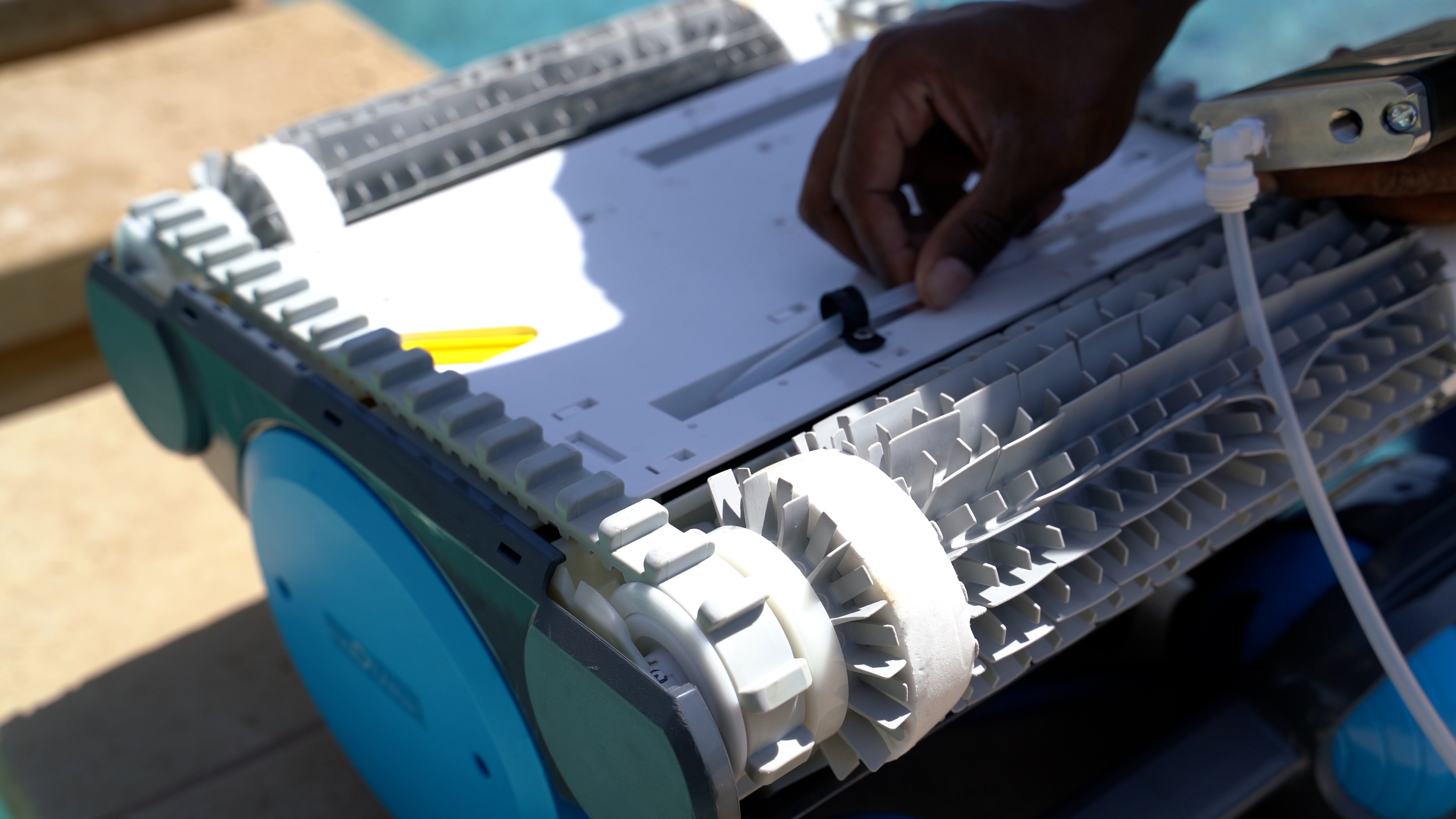 Dolphin Premier Hand Attaching Cable To Robotic Cleaner