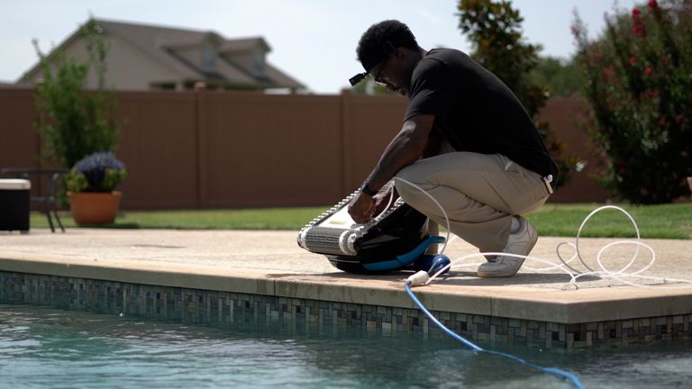 Dolphin Nautilus CC Plus Reviewer Prepping Robot On Pool Deck