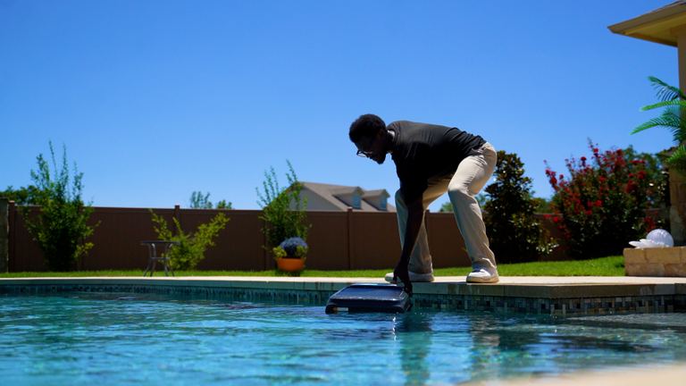 Aiper Surfer S2 Releasing Onto Water From Pool Edge