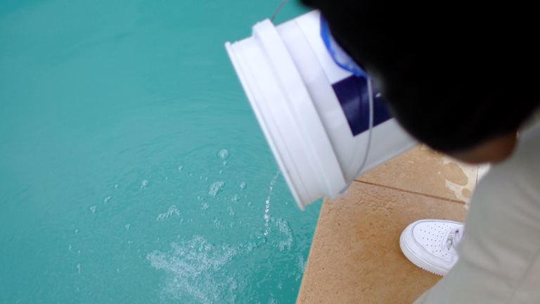 Pool Maintenance Last Drips From Upended Bucket Into Pool