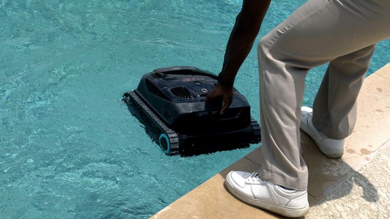 Aiper Scuba X1 Hand Placing Unit Into Pool Water