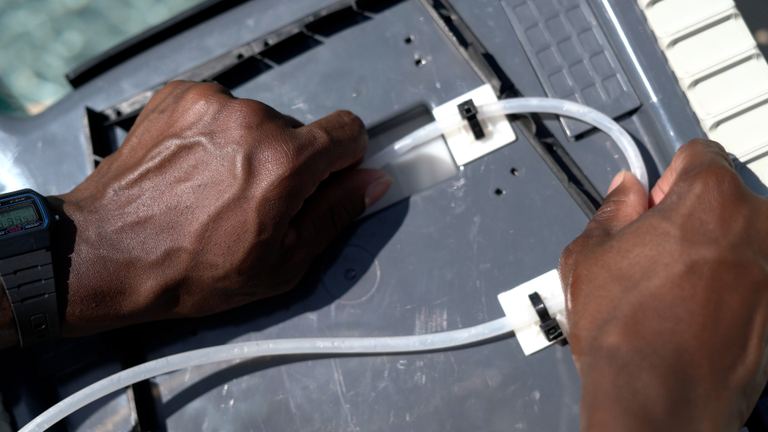Dolphin Quantum Hands Attaching Tube To Pool Cleaner