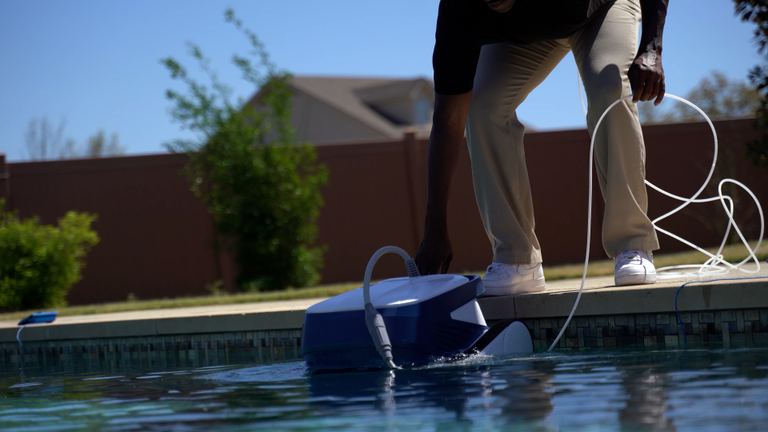Clear UV Placing Into Water At Pool Edge