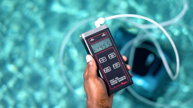 Beatbot AquaSense 2 Pro Hand Holding Pressure Meter Above Water